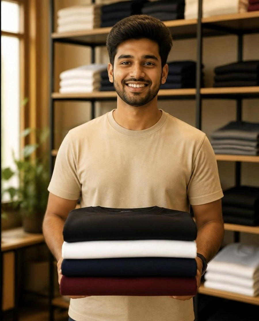Reseller holding a stack of folded blank T-shirts for wholesale resale